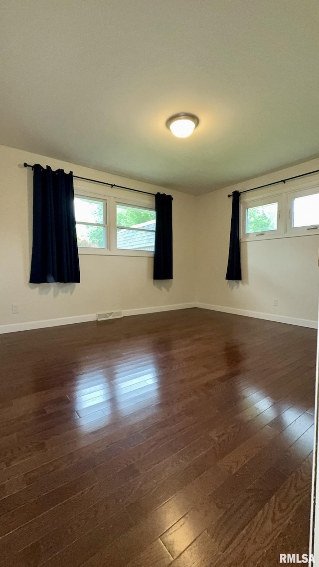 112 Prairie Rd, Carterville, IL 62918 - spare room with dark wood-style floors, plenty of natural light, and baseboards