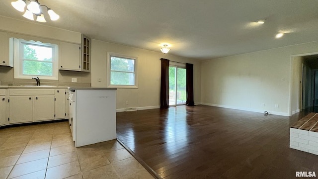 112 Prairie Rd, Carterville, IL 62918 - kitchen featuring a chandelier, plenty of natural light, open floor plan, and white cabinetry