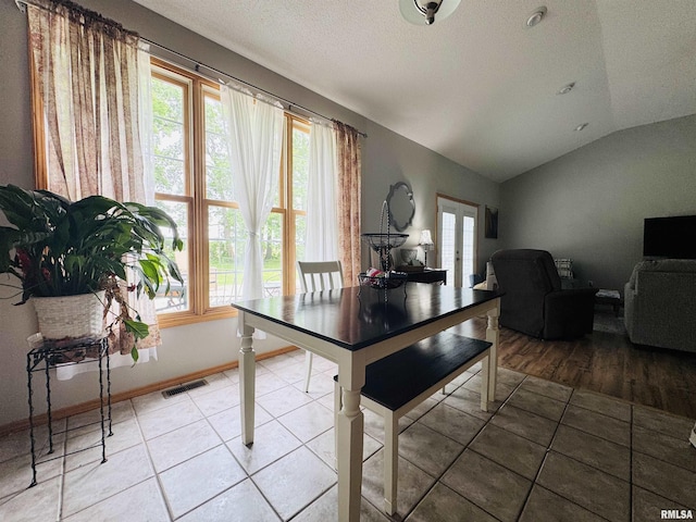 3621 Andrews Ct, Salem, IL 62881 - dining area featuring lofted ceiling, french doors, light tile patterned floors, a textured ceiling, and baseboards