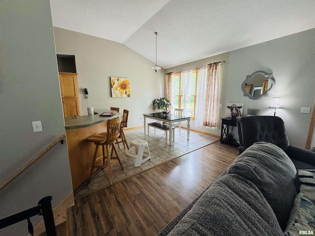 3621 Andrews Ct, Salem, IL 62881 - living area featuring wood finished floors, vaulted ceiling, baseboards, and a textured ceiling