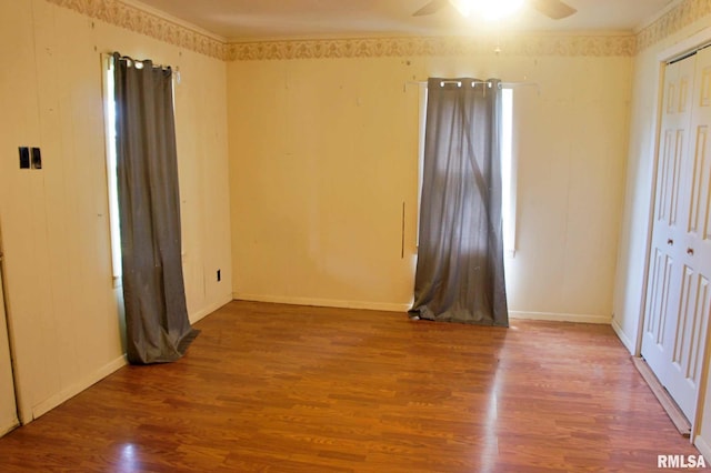 207 Butler St, Metropolis, IL 62960 - unfurnished bedroom with wood finished floors, a closet, baseboards, and a ceiling fan