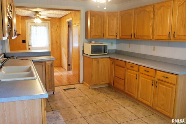 207 Butler St, Metropolis, IL 62960 - kitchen with a ceiling fan, a sink, light tile patterned flooring, light countertops, and ornamental molding