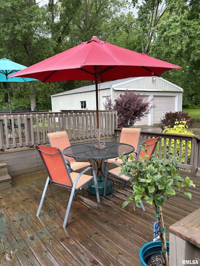13916 Leisure Ln, Benton, IL 62812 - wooden deck with outdoor dining area, view of wooded area, and an outdoor structure