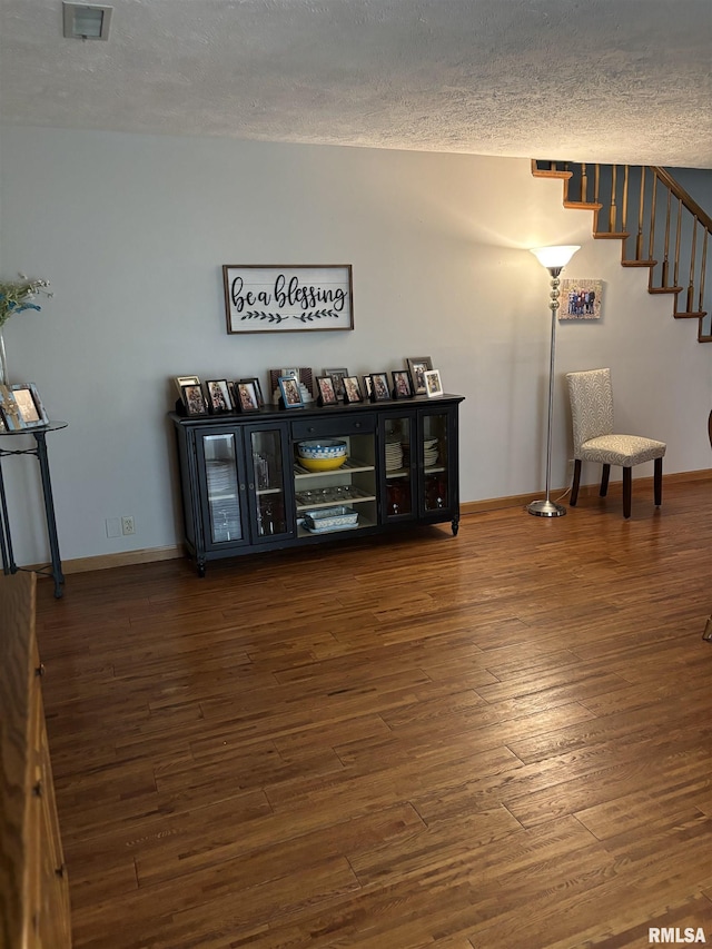 13916 Leisure Ln, Benton, IL 62812 - living room featuring a textured ceiling, wood finished floors, baseboards, and stairway