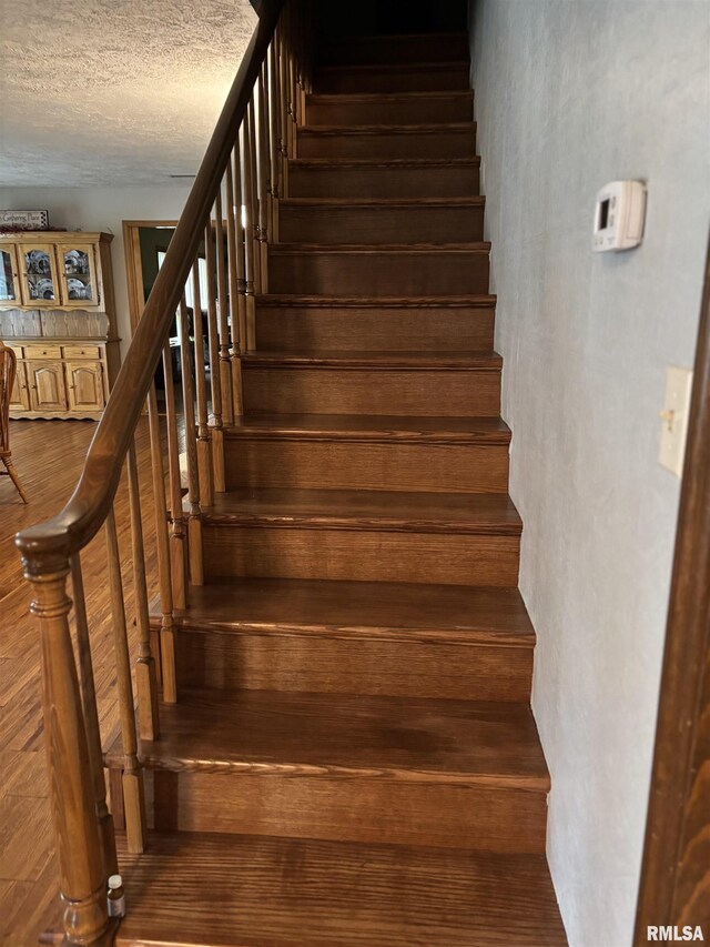 13916 Leisure Ln, Benton, IL 62812 - stairway with wood finished floors and a textured ceiling