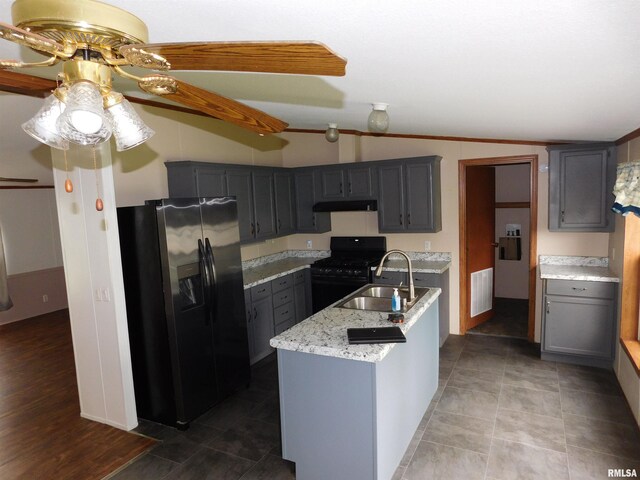 403 E Sycamore St, Kinmundy, IL 62854 - kitchen with fridge with ice dispenser, a sink, black range with gas stovetop, under cabinet range hood, and ceiling fan