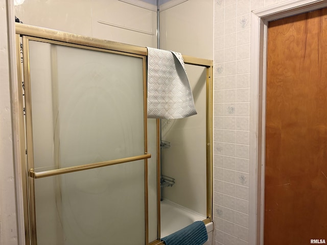 bathroom with a shower with shower door and tile walls