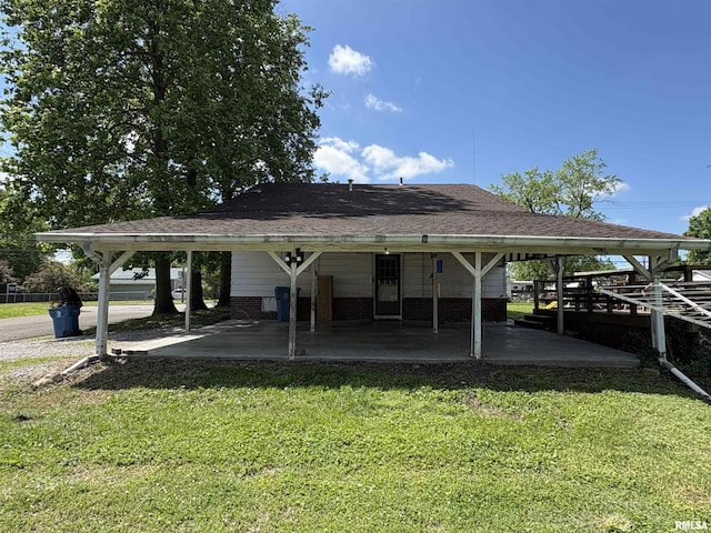 view of community featuring a lawn and a carport