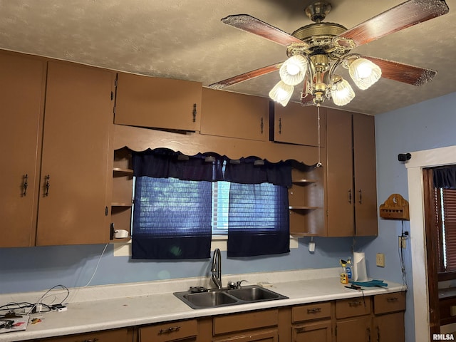 kitchen featuring a sink, open shelves, ceiling fan, and light countertops