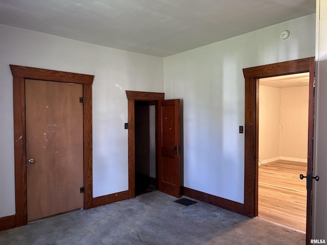 unfurnished bedroom with carpet and baseboards