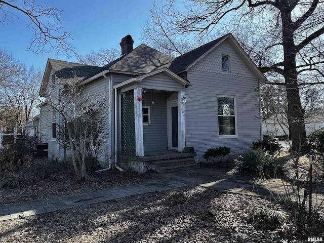 402 S Main St, Benton, IL 62812 - victorian-style house featuring a chimney and roof with shingles