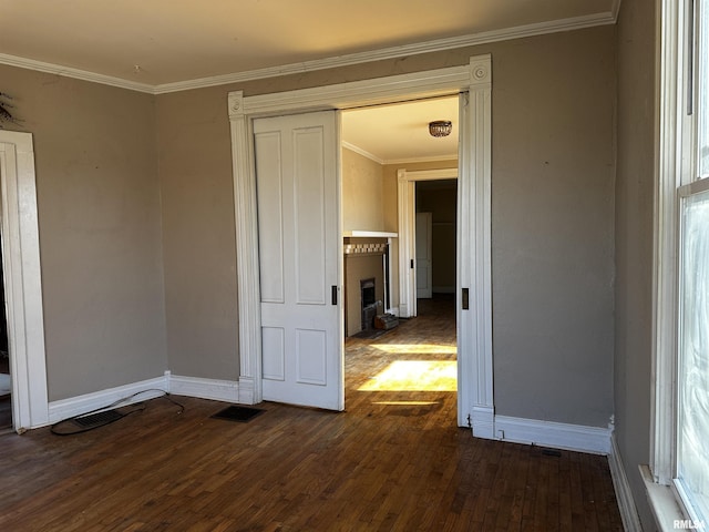 402 S Main St, Benton, IL 62812 - unfurnished room with dark wood-style floors, baseboards, crown molding, and a fireplace