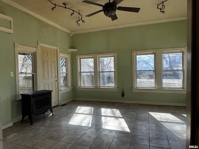 402 S Main St, Benton, IL 62812 - entryway featuring track lighting, baseboards, a ceiling fan, ornamental molding, and a wood stove