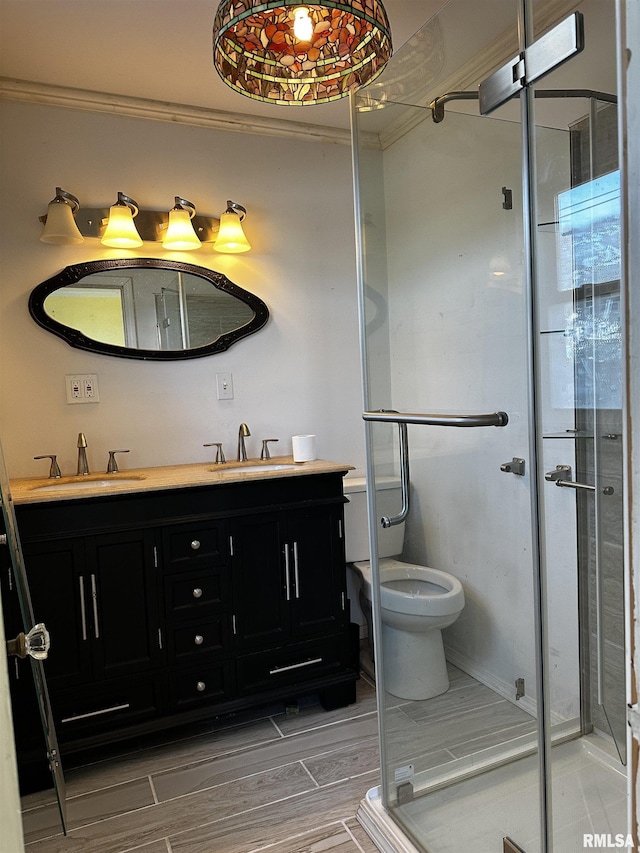 402 S Main St, Benton, IL 62812 - bathroom featuring double vanity, a stall shower, toilet, wood finish floors, and baseboards