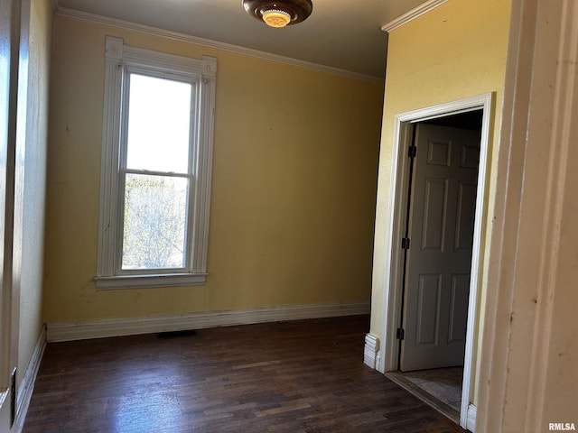 402 S Main St, Benton, IL 62812 - empty room with healthy amount of natural light, crown molding, baseboards, and wood finished floors