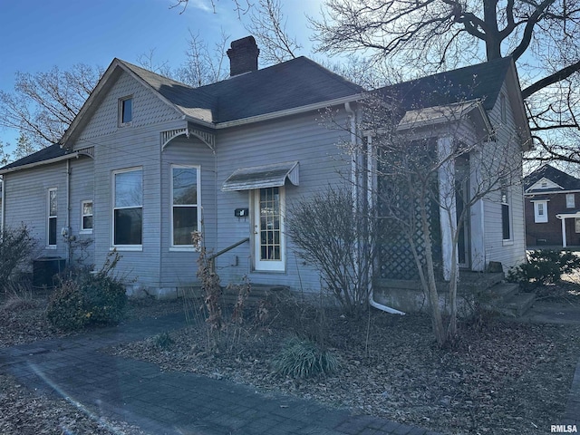 402 S Main St, Benton, IL 62812 - view of front of property featuring a chimney, central AC unit, and entry steps