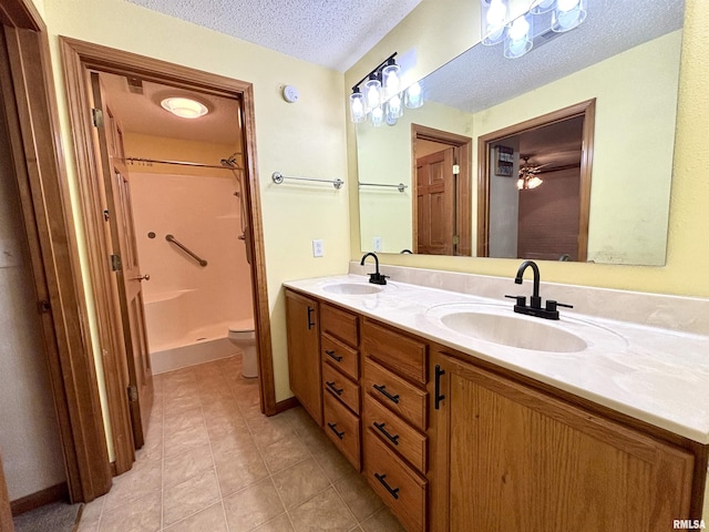 7544 Geranium Rd, Oakdale, IL 62268 - bathroom with a textured ceiling, a shower, toilet, tile patterned flooring, and double vanity