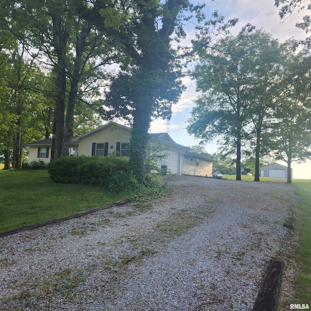 15267 N Woodlawn Ln, Woodlawn, IL 62898 - view of home's exterior featuring gravel driveway and a yard