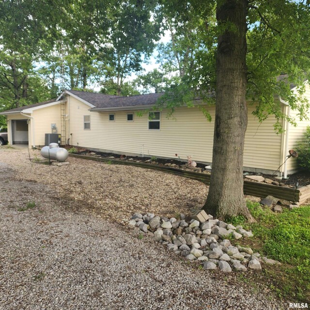 15267 N Woodlawn Ln, Woodlawn, IL 62898 - view of home's exterior featuring central air condition unit and driveway
