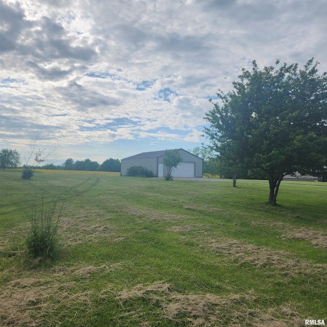 15267 N Woodlawn Ln, Woodlawn, IL 62898 - view of green lawn featuring a detached garage, an outdoor structure, an outbuilding, and a rural view