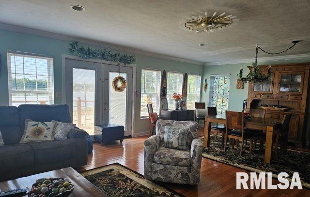 160 Front St, Elizabethtown, IL 62931 - living area featuring crown molding, wood finished floors, and a chandelier