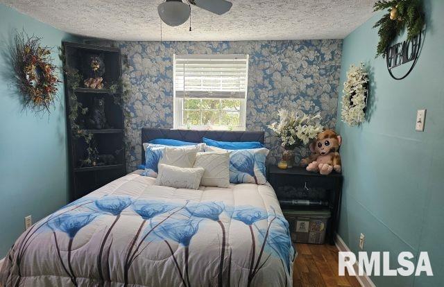 160 Front St, Elizabethtown, IL 62931 - bedroom with a textured ceiling, wood finished floors, baseboards, and ceiling fan