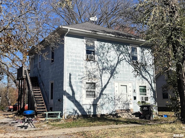 310 W Pecan St, Carbondale, IL 62901 - view of property exterior with stairway, roof with shingles, and cooling unit