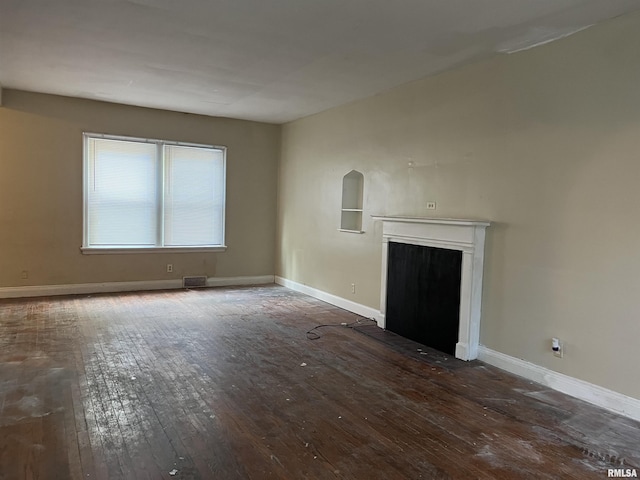 404 W Elm St, Carbondale, IL 62901 - unfurnished living room featuring wood-type flooring, a fireplace with flush hearth, and baseboards