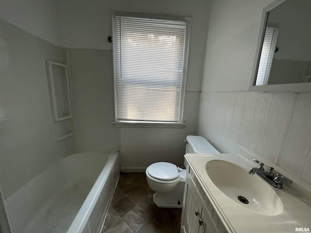 404 W Elm St, Carbondale, IL 62901 - full bathroom with toilet, a bath, tile walls, healthy amount of natural light, and vanity