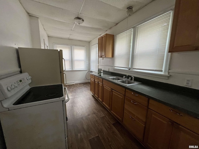 404 W Elm St, Carbondale, IL 62901 - kitchen with a sink, white appliances, brown cabinets, dark countertops, and a drop ceiling