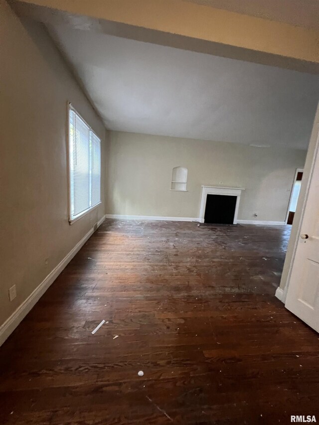 404 W Elm St, Carbondale, IL 62901 - unfurnished living room featuring baseboards, a fireplace, and dark wood-style flooring