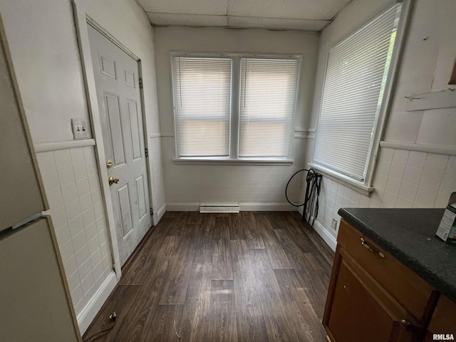 404 W Elm St, Carbondale, IL 62901 - unfurnished dining area with dark wood finished floors, a paneled ceiling, and baseboards