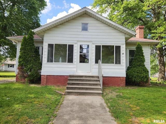 105 E Rea St, Valier, IL 62891 - bungalow featuring entry steps, a front yard, and a chimney