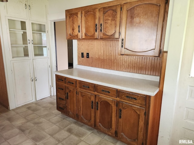 105 E Rea St, Valier, IL 62891 - kitchen with light countertops, brown cabinets, wooden walls, and wainscoting