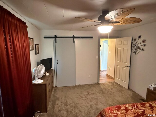 6556 S US-45 Rd, Brookport, IL 62910 - bedroom with a barn door, carpet flooring, and ceiling fan