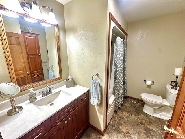 23208 N US Highway 51, Centralia, IL 62801 - full bath featuring toilet, stone finish flooring, baseboards, vanity, and shower / tub combo