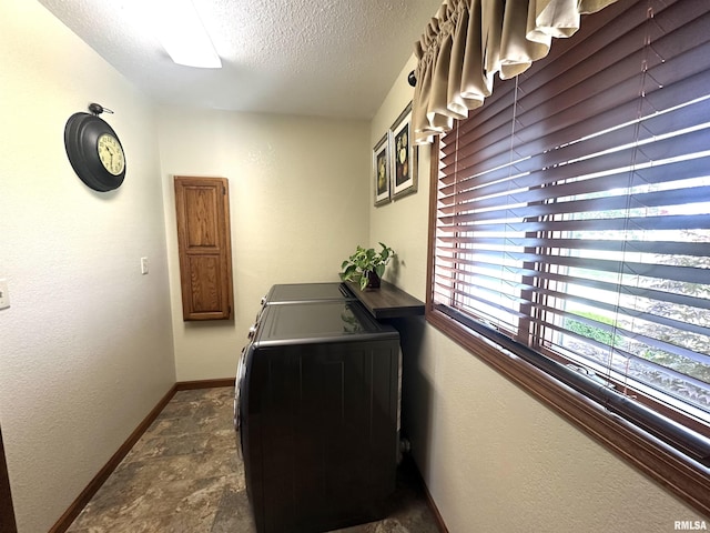 23208 N US Highway 51, Centralia, IL 62801 - laundry room featuring washing machine and dryer, a textured ceiling, baseboards, and stone finish flooring