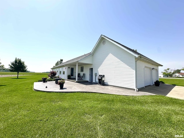 23208 N US Highway 51, Centralia, IL 62801 - back of house with a lawn, an attached garage, and a patio area