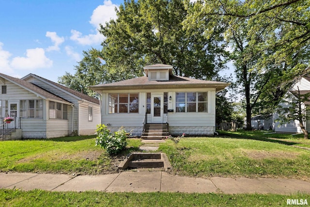515 E Calumet St, Centralia, IL 62801 - bungalow-style house with a front lawn, a sunroom, and entry steps