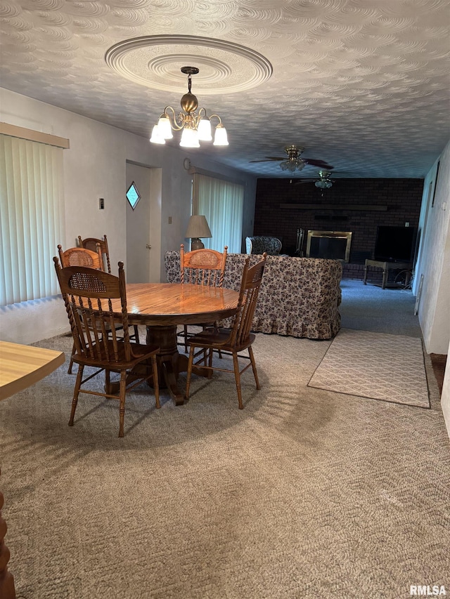 405 S Park Ct, Percy, IL 62292 - carpeted dining space with a chandelier, a fireplace, a ceiling fan, and a textured ceiling
