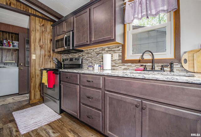 631 Community Beach Rd, Centralia, IL 62801 - kitchen featuring stainless steel appliances, washer / clothes dryer, a sink, dark wood-style flooring, and backsplash