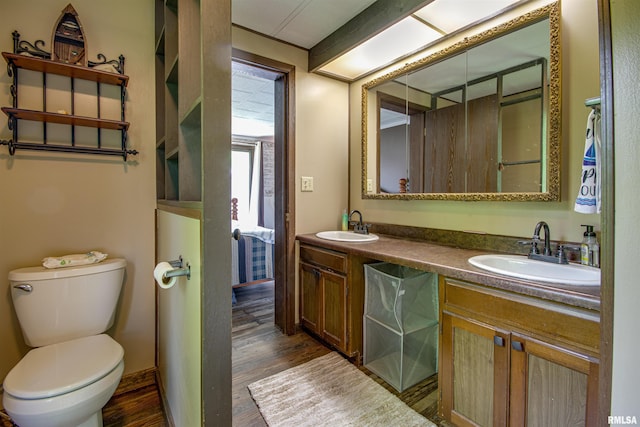 631 Community Beach Rd, Centralia, IL 62801 - bathroom featuring double vanity, toilet, and wood finished floors
