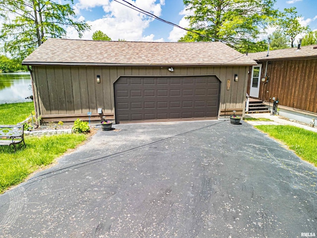 631 Community Beach Rd, Centralia, IL 62801 - view of front of home featuring asphalt driveway, a garage, and roof with shingles