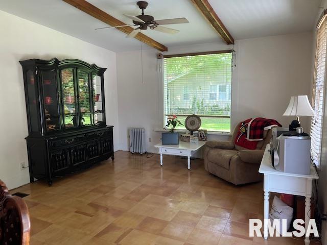 living room with radiator, beamed ceiling, and a ceiling fan