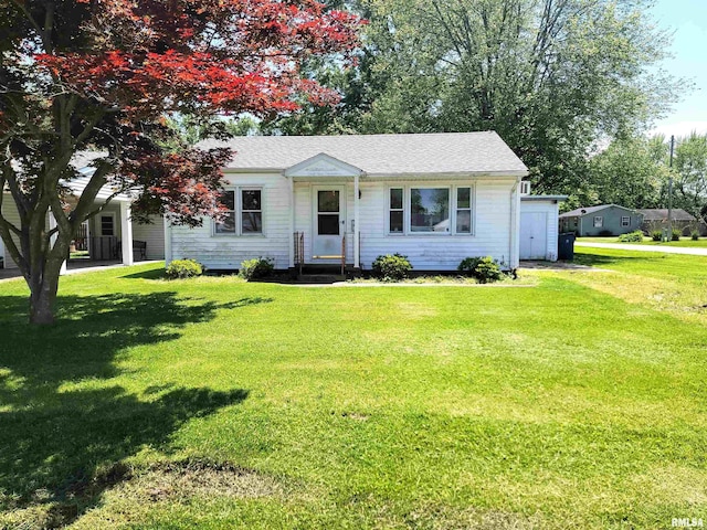 225 Hickory St, Flora, IL 62839 - view of front of property featuring a front lawn and a shingled roof