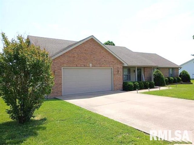 103 Chase Ln, Marion, IL 62959 - single story home featuring an attached garage, brick siding, driveway, and a front lawn