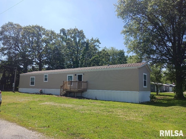 view of front of property with a front yard and a wooden deck
