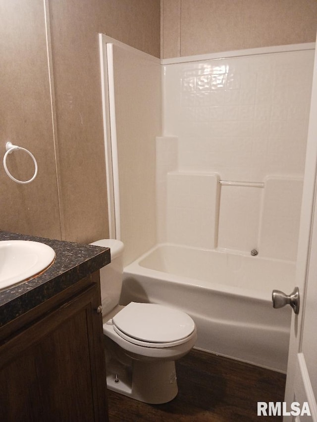 full bathroom featuring wood finished floors, vanity, toilet, and shower / tub combination