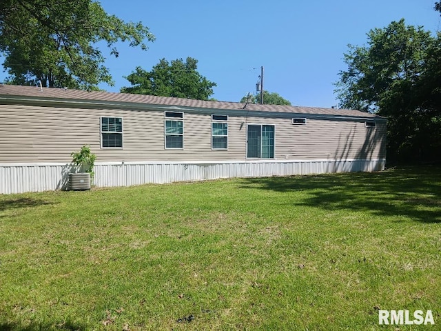 rear view of property with a lawn
