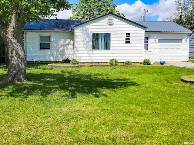 214 W 12th St, Flora, IL 62839 - view of front of property featuring an attached garage, a front yard, driveway, and metal roof